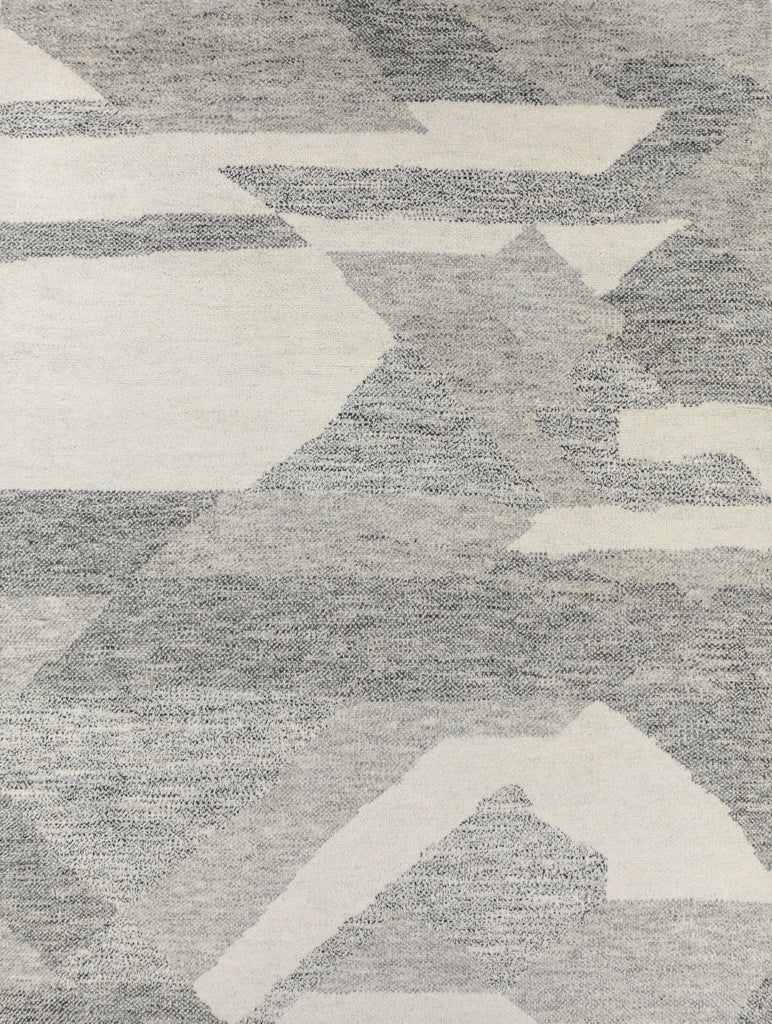 Geometric and contemporary handmade rug with an organic bohemian design and neutral beige, ivory, grey, black rug made of wool and viscose with a soft, plush pile.
