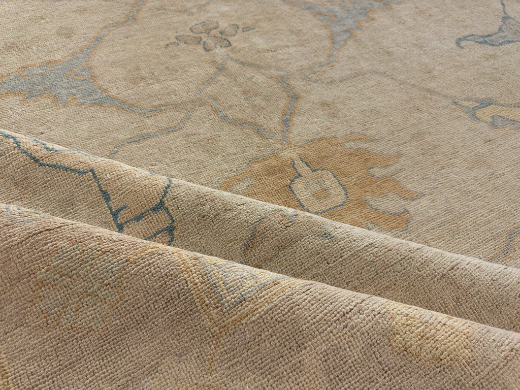 Light lavender muted rug with warm grey beige, butterscotch orange and blue hand knotted wool area rug.