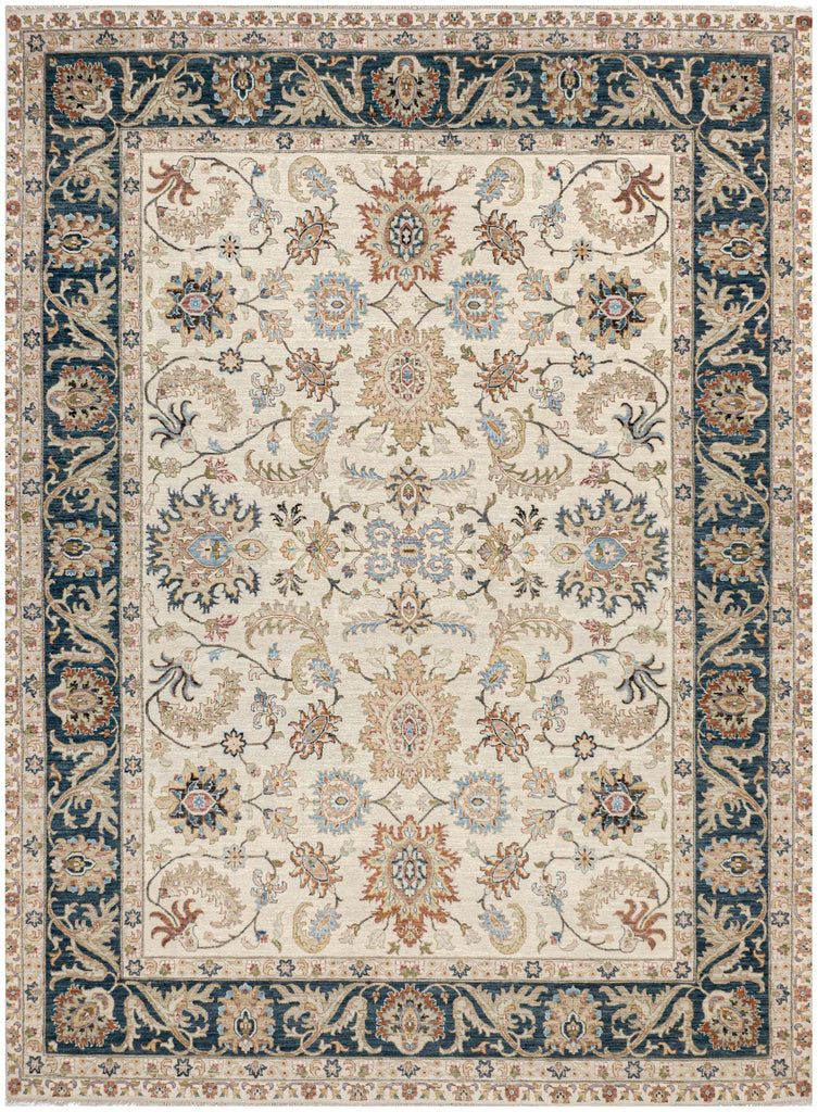 9x12 hand knotted wool rug with ivory background, navy border, and multicolor floral design in green, gold, red, black, and earthy shades.