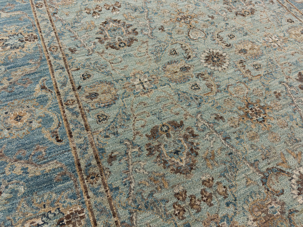 Floral robins egg blue rug with cyan background and brown accents.