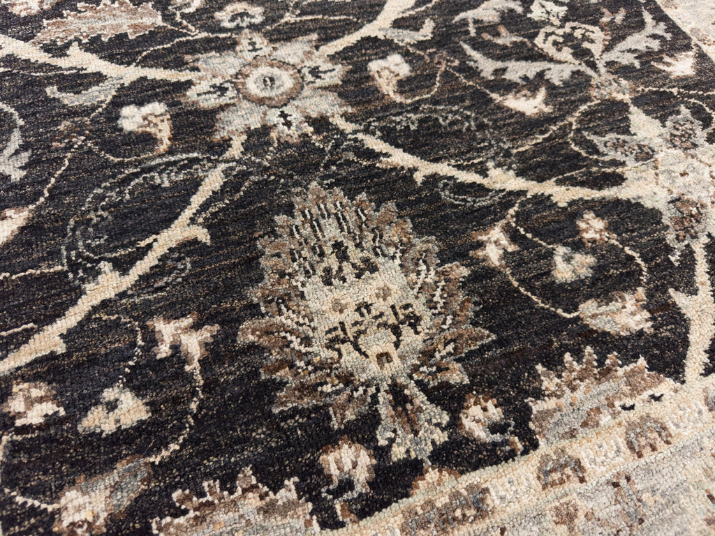 Black wool area rug with artichoke flower.