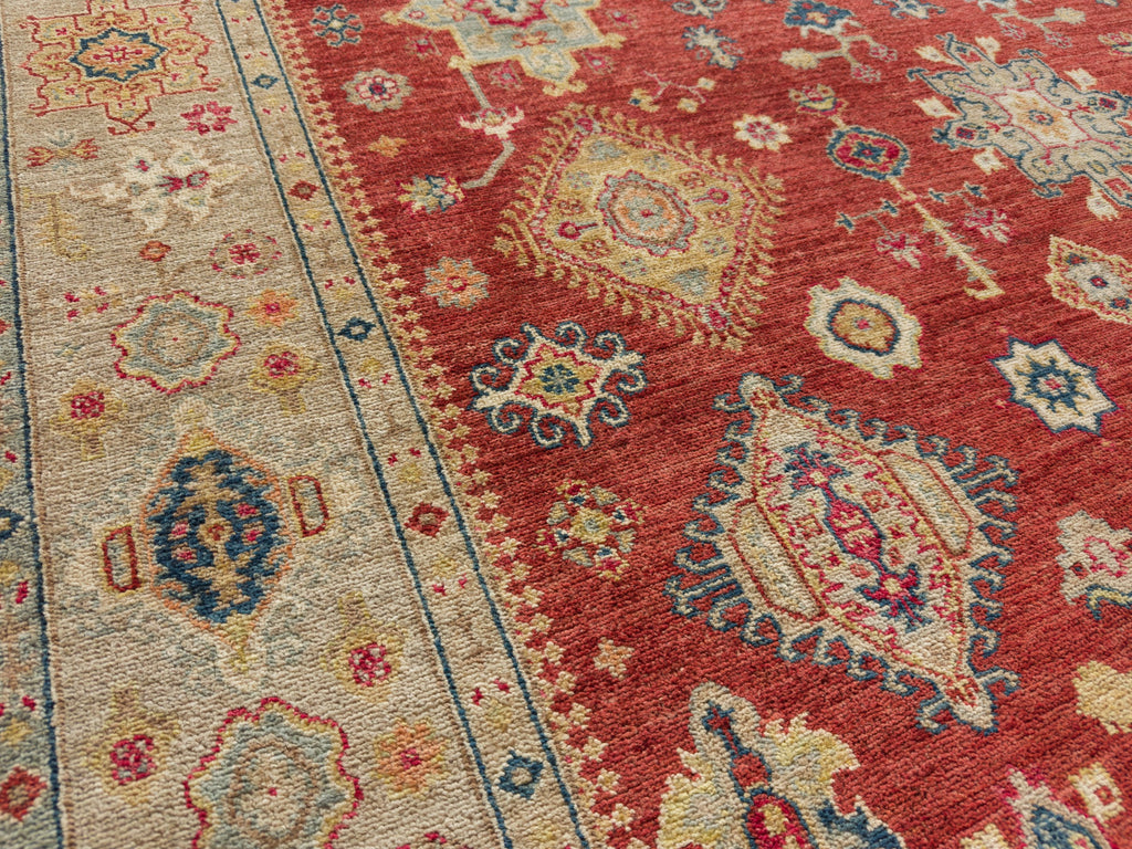 6' x 9' bright red traditional rug in geometric design.