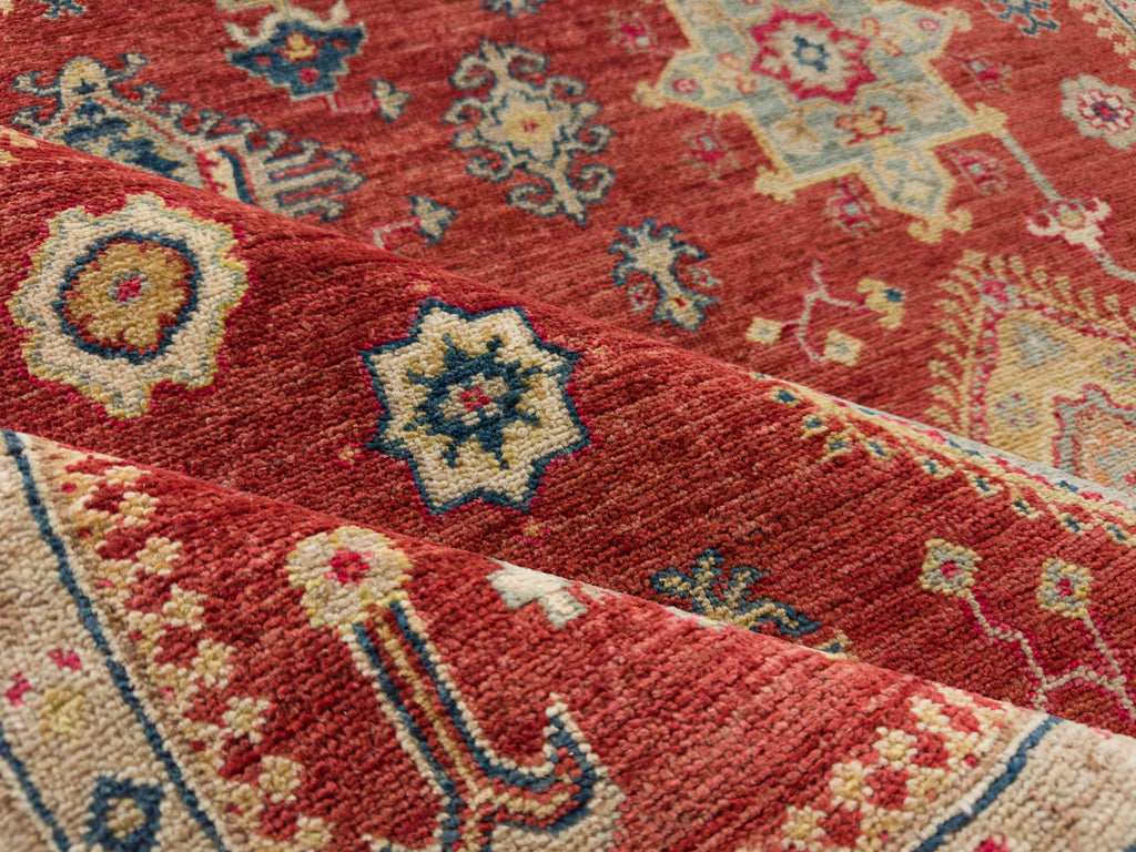 Hand knotted lip stick red 6x9 rug with navy, gold and beige with southwest pattern.
