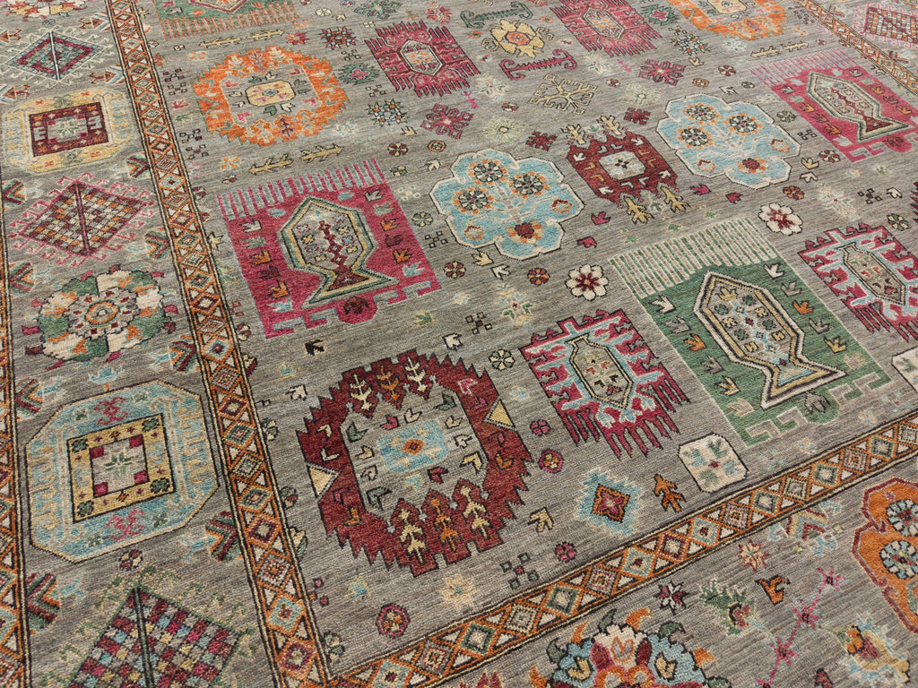 Bold tribal rug with lots of color such as pink, deep red, green, light blue, orange and grey.
