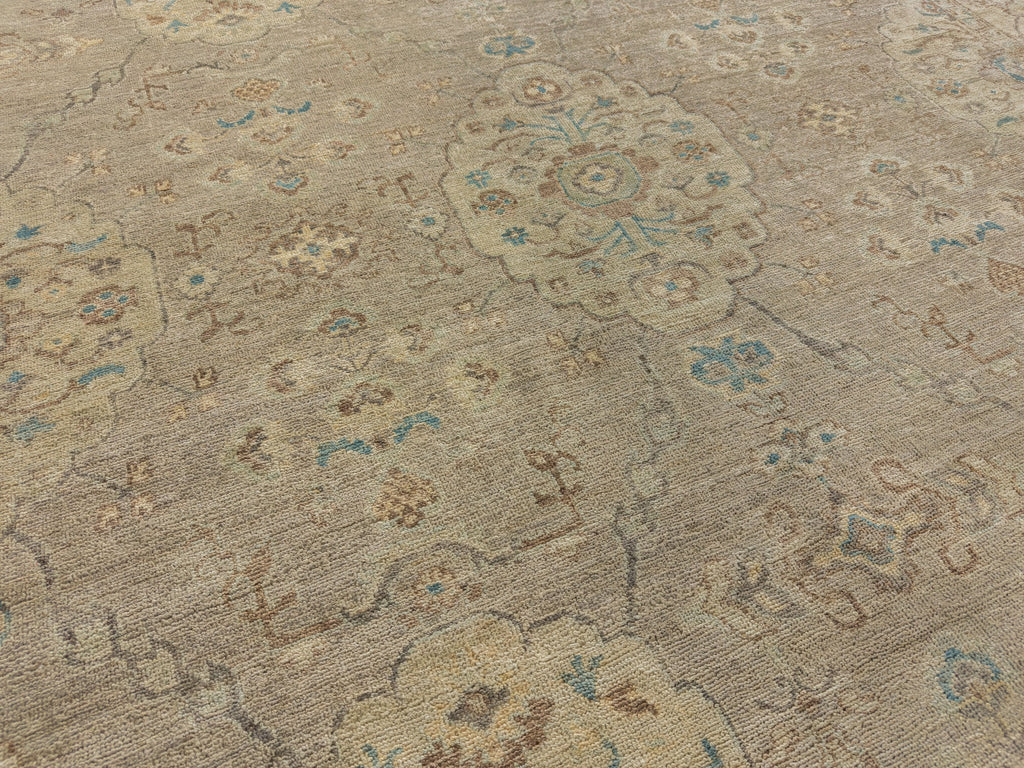 Light pewter rug with muted green accents, brown medallions, blue florals and grey accents made of wool.