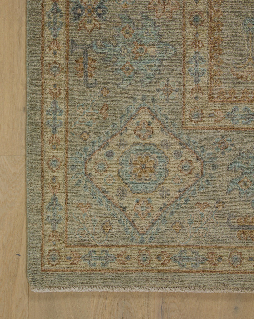 8x10 hand knotted wool rug in green grey with Carolina blue, indigo, beige and saddle brown.