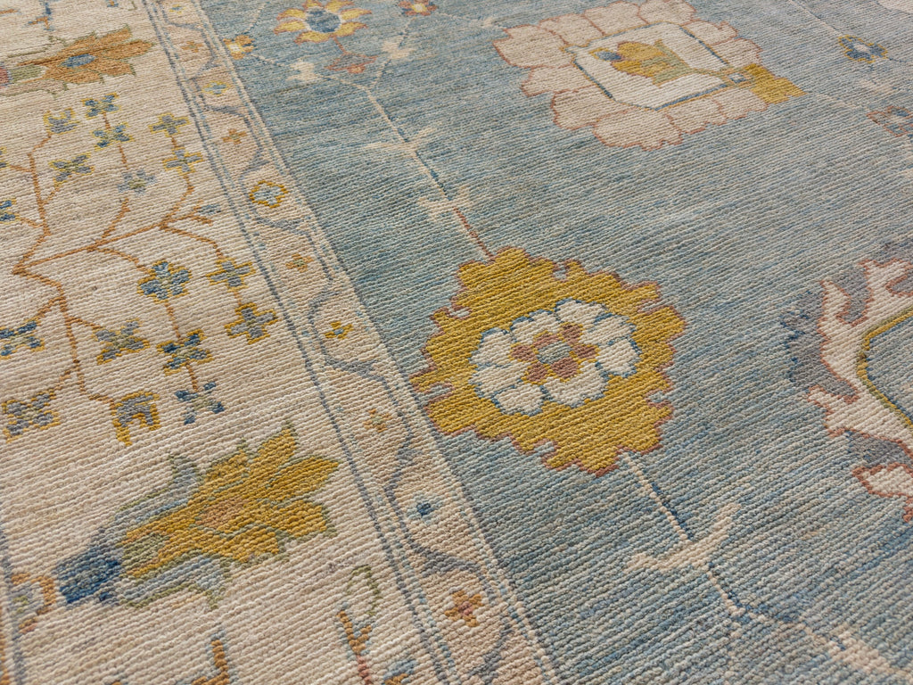 Saffron rug with ivory, light blue, sage and coral.