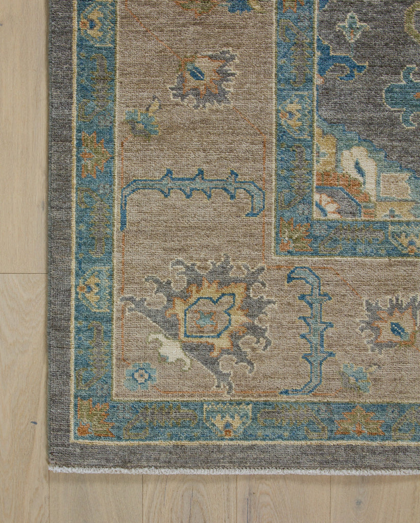 Vibrant aqua area rug hand knotted wool with beige, orange, and dark grey.