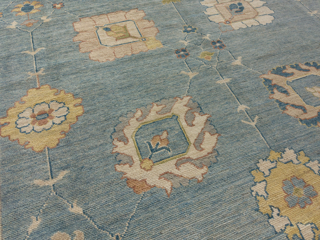 Luxury 9x12 hand knotted wool area rug in light blue, navy, gold, grey and sage green.