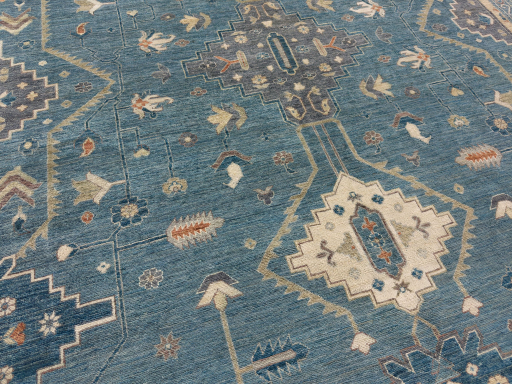 Grey medallion rug hand knotted of wool with quality ivory, teal, blue and orange accents.