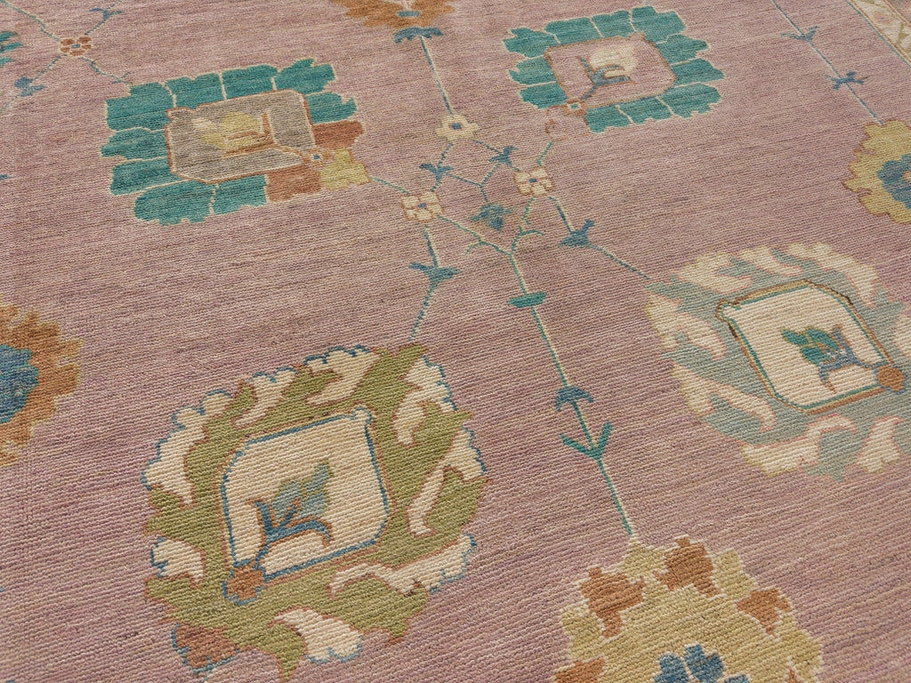 9x12 pink oushak rug with green, spa, turquoise, gold and dark blue.
