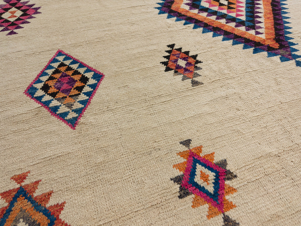 Hand knotted wool shag boho rug with bright pink, magenta, black, dark blue and orange.