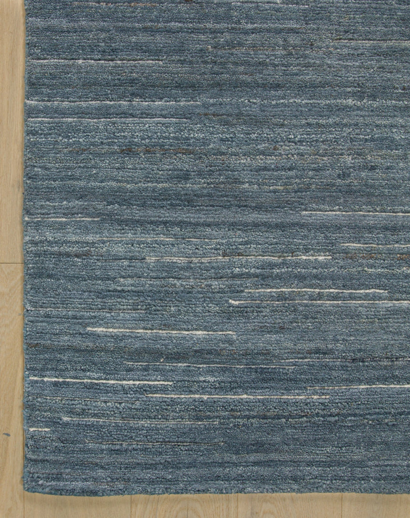 Hand knotted solid denim rug hand knotted wool with linear off-white and grey accents and transitional linear design.
