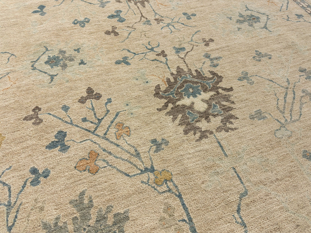 Brown oriental wool rug 8x10 with spa mist, blue, gold, grey and orange accent colors in floral design.