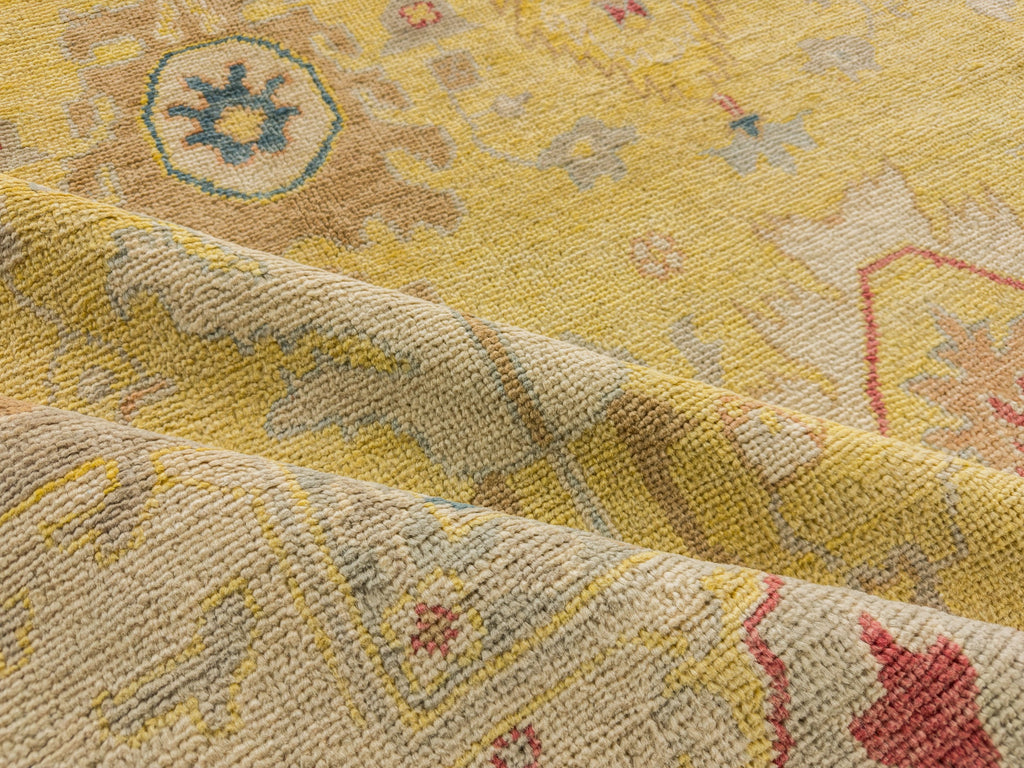 Sunshine yellow rug traditional hand knotted of wool with coral, beige, teal and brown accents.