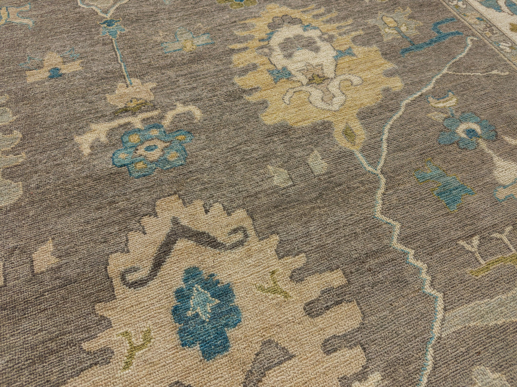 Hand knotted grey floral wool rug with bright citron green, aqua blue, muted gold, mist and beige.