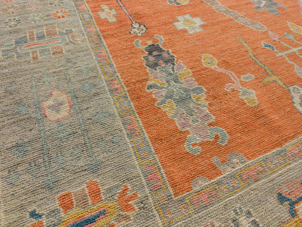 Grey and orange oriental area rug with spa, light purple, pink, gold and blue colors by Roya Rugs Hickory NC.