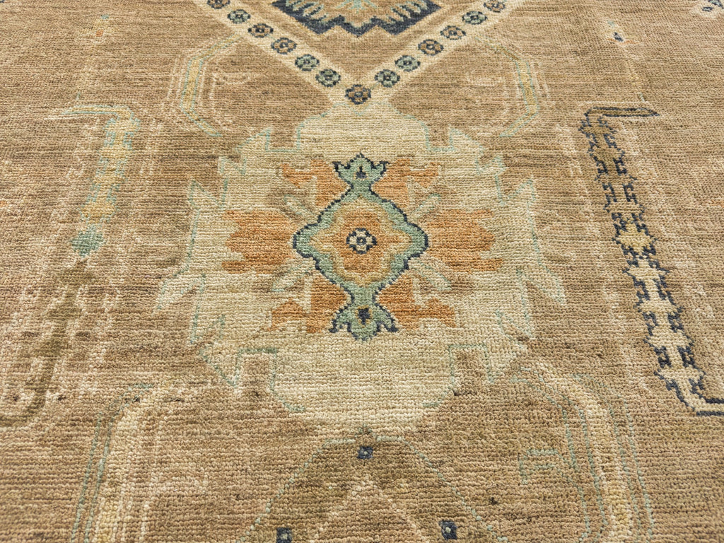Floral geometric rug hand knotted wool with orange, mint green, sisal color and beige accents.