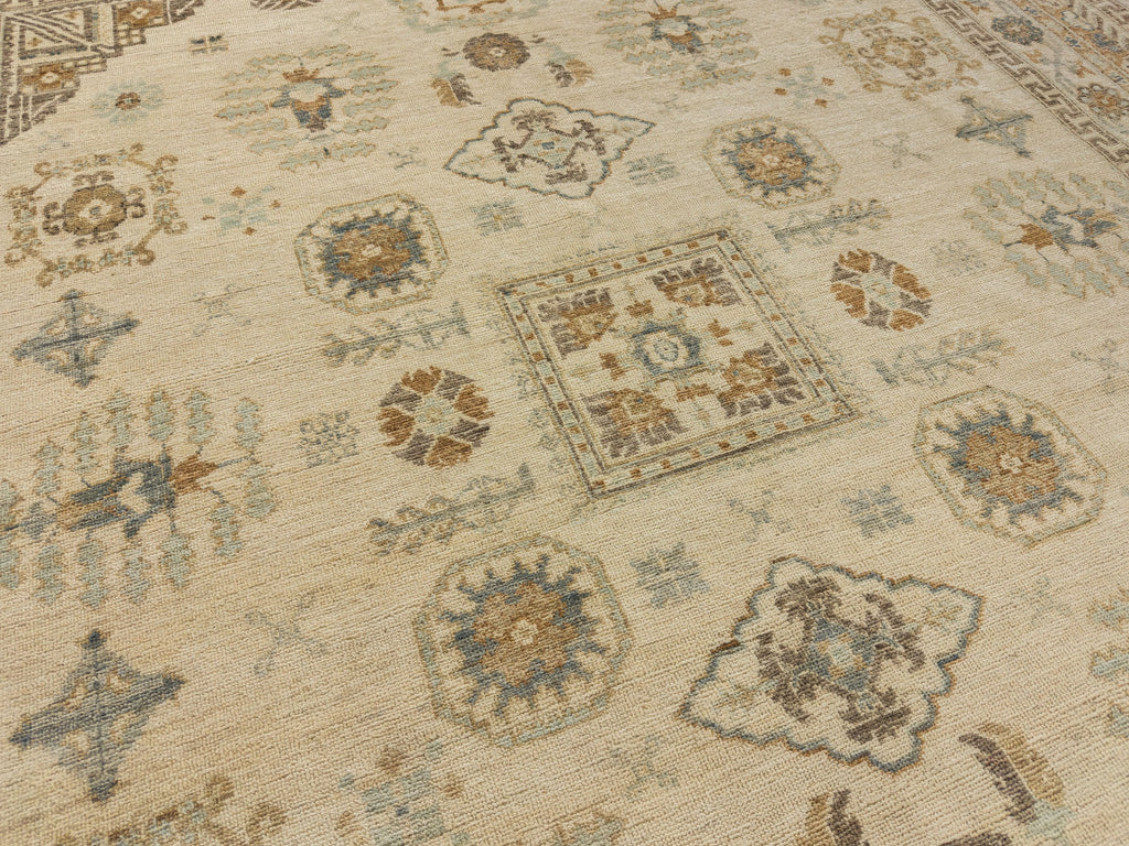 Unique oriental rug in neutral ivory with spa, blue, mist green and brown accents with medallion design.