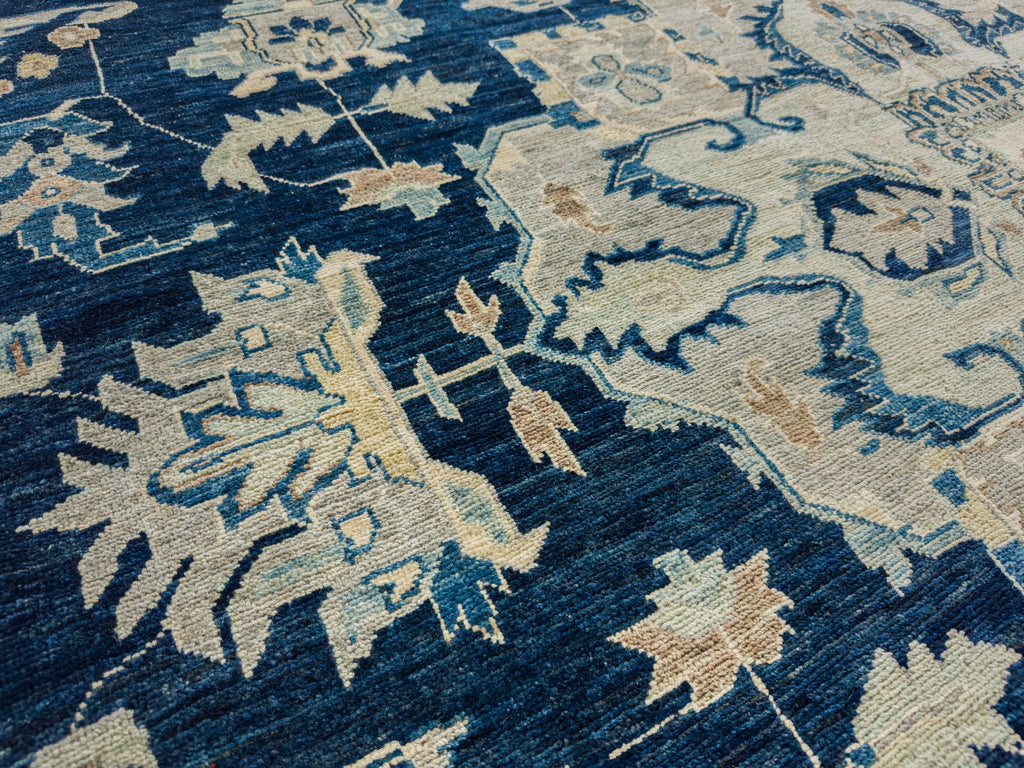 Dark navy blue oriental wool rug with aqua, brown, beige, grey and light gold accent colors.