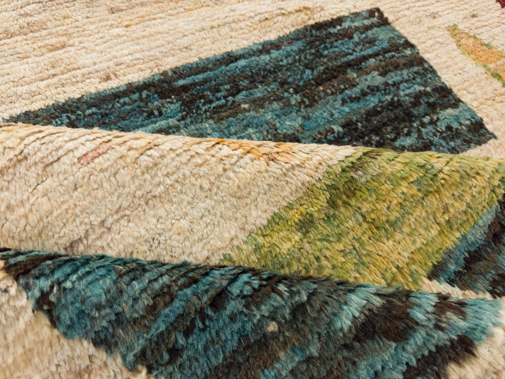Hand knotted colorful shag wool rug 6x8 with avocado green, teal, orange and ivory/beige.