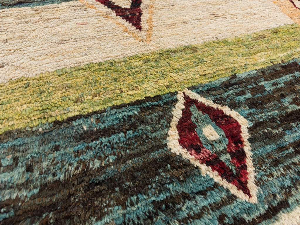 Geometric southwest rug 6x8 in colorful dark red, teal, dark black brown, natural ivory and avocado green colors.