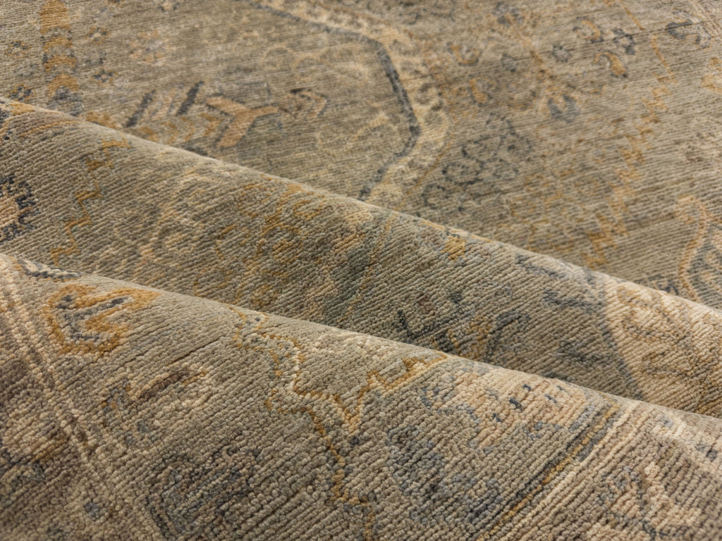 light green hand knotted wool rug with gold, brown, grey, blue and medallion 6x9.