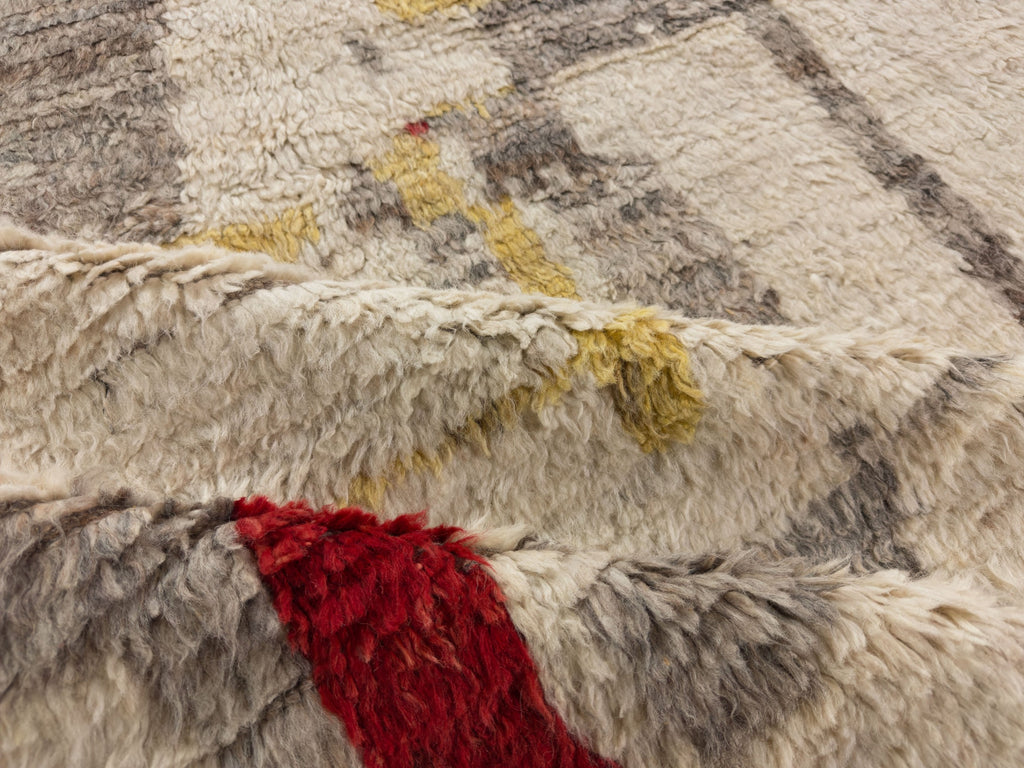 Colorful boho shag rug with mid century modern design in gold, red, ivory, brown and grey.