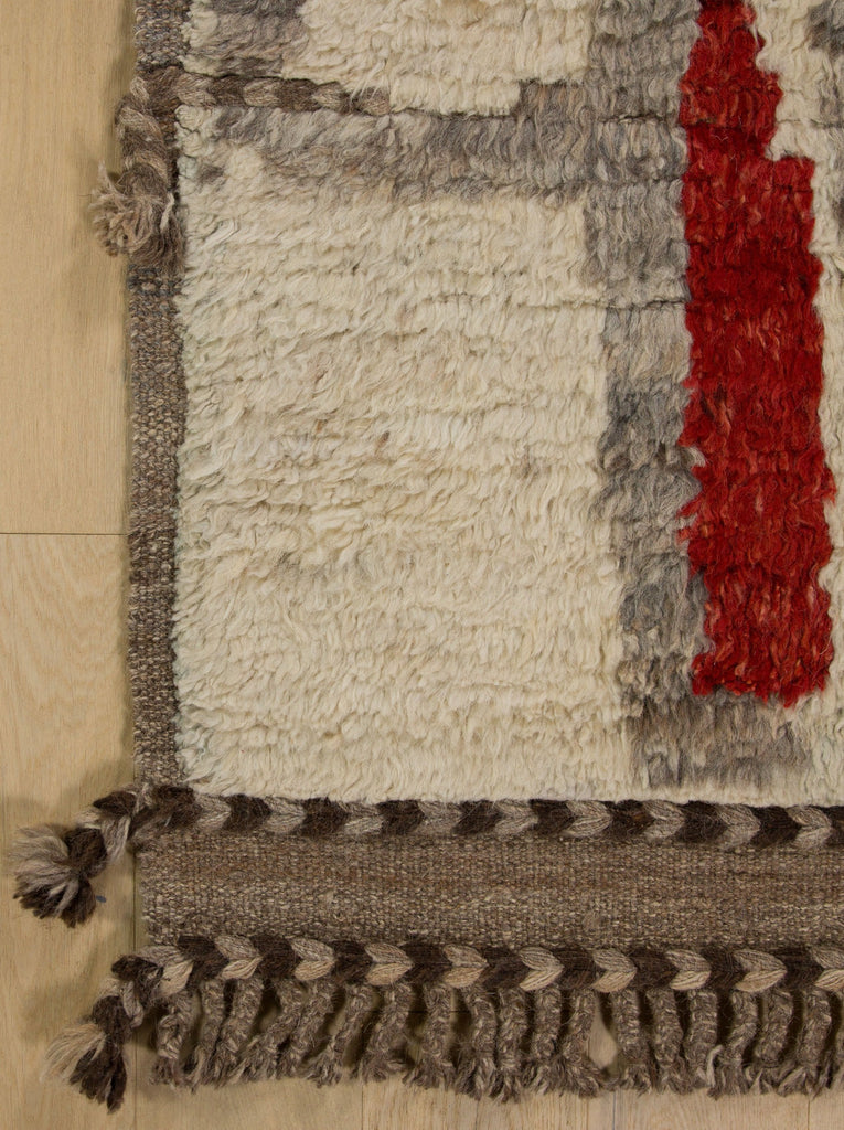 Mid century modern rug in red, ivory, grey and earth tone colors with hand knotted wool pile.