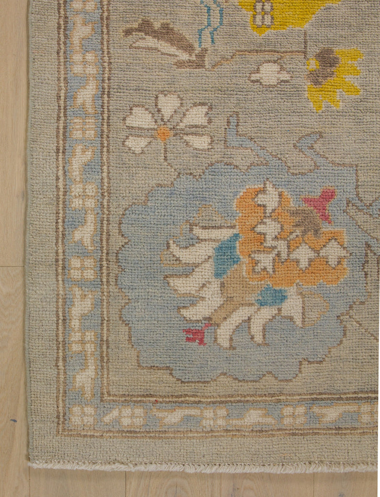 Momeni hand knotted grey traditional oriental wool rug Roya Rugs with periwinkle, blue, bright yellow and red.