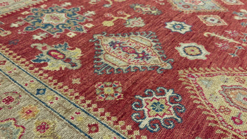 Tomato red 6x9 wool rug hand knotted with light blue and navy.