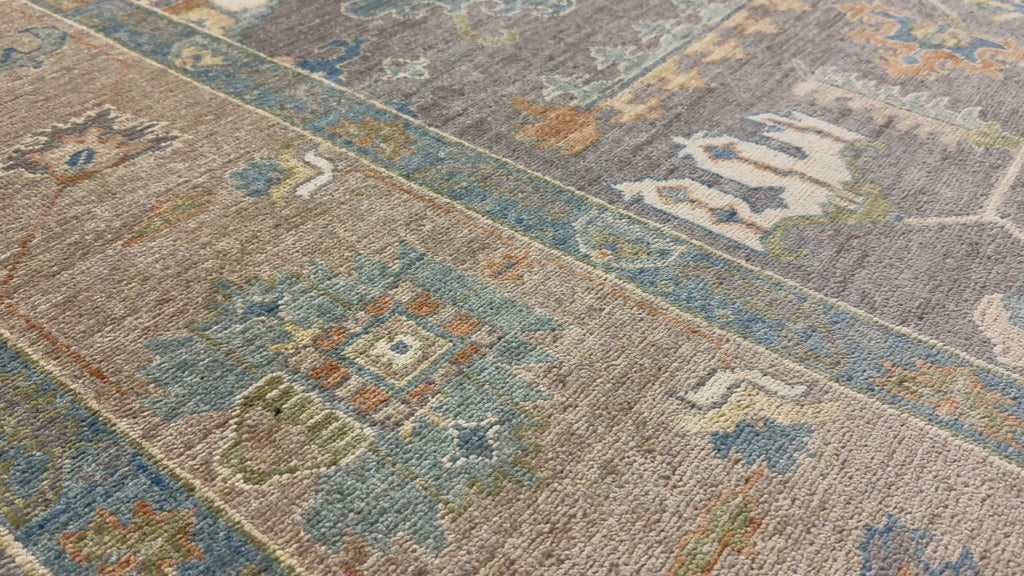 Hand knotted dark grey modern tribal rug with orange, beige, ivory, sage and blue.