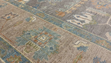 Hand knotted dark grey modern tribal rug with orange, beige, ivory, sage and blue.