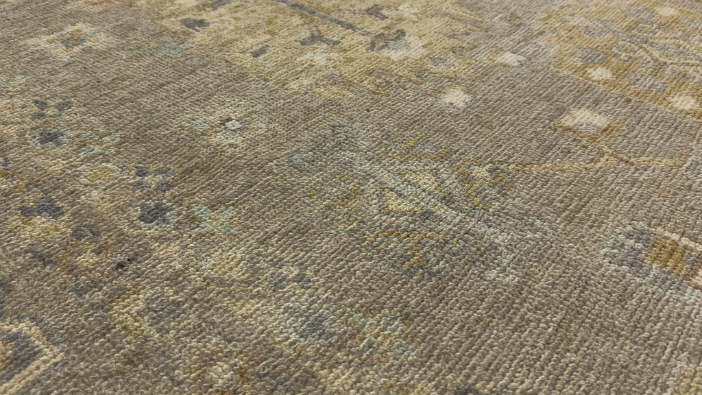 9x12 hand knotted soft neutral Turkish wool rug with mossy green, slate and brass.