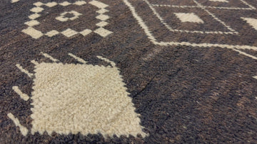 8x10 dark brown tribal rug with warm beige accents and organic wool shag fibers.