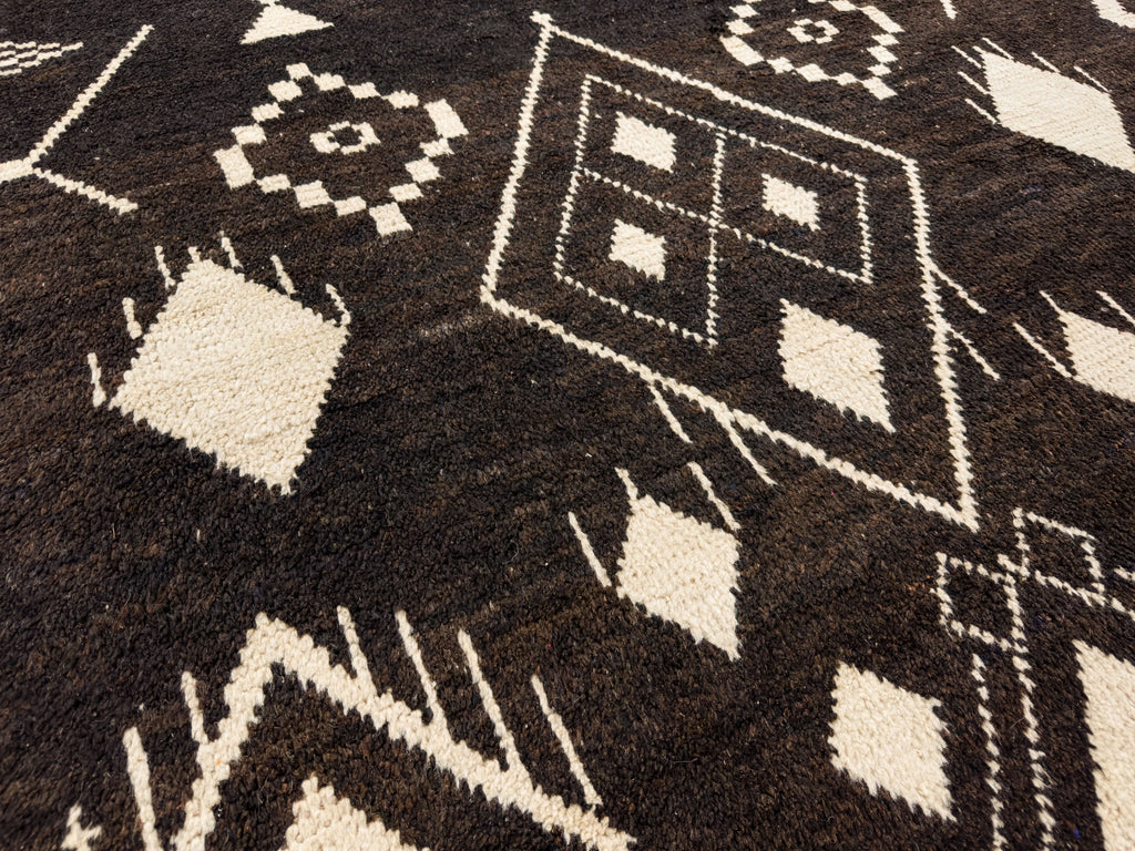 one of a kind tribal rug 8x10 made of wool with dark brown and beige diamond design accents.