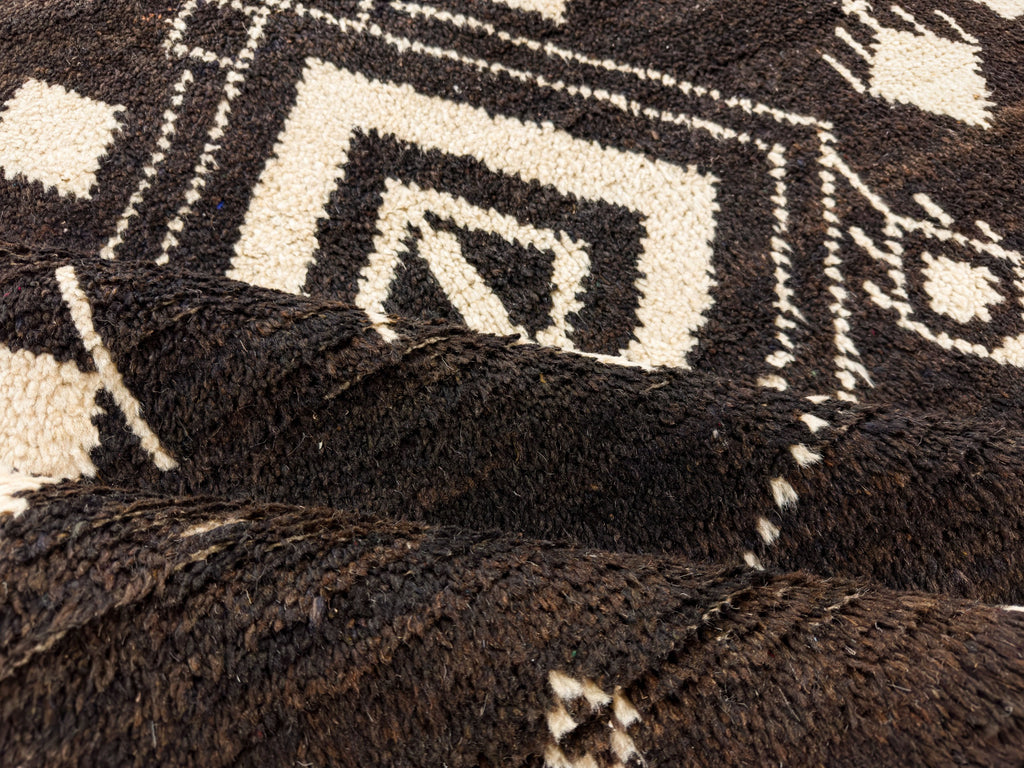 Chocolate brown wool rug with shag pile with beige diamond accents.