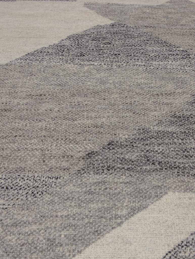 Hand Knotted wool and viscose rug with a soft pile and geometric design inspired by the African landscape. Bohemian look with ivory, gray, brown and black colors.  