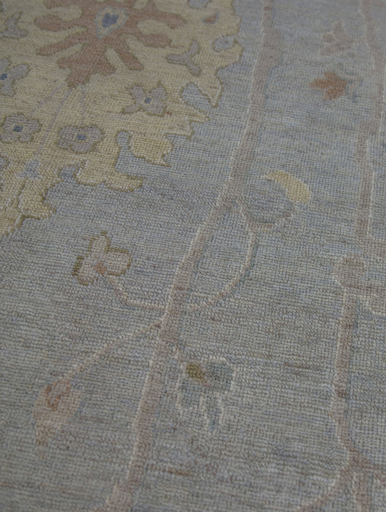 Light green gray with ivory brown blue colored 10x14 turkish oushak wool rug.