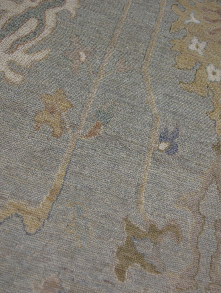 Light green gray with ivory brown blue colored 10x14 turkish oushak wool rug.