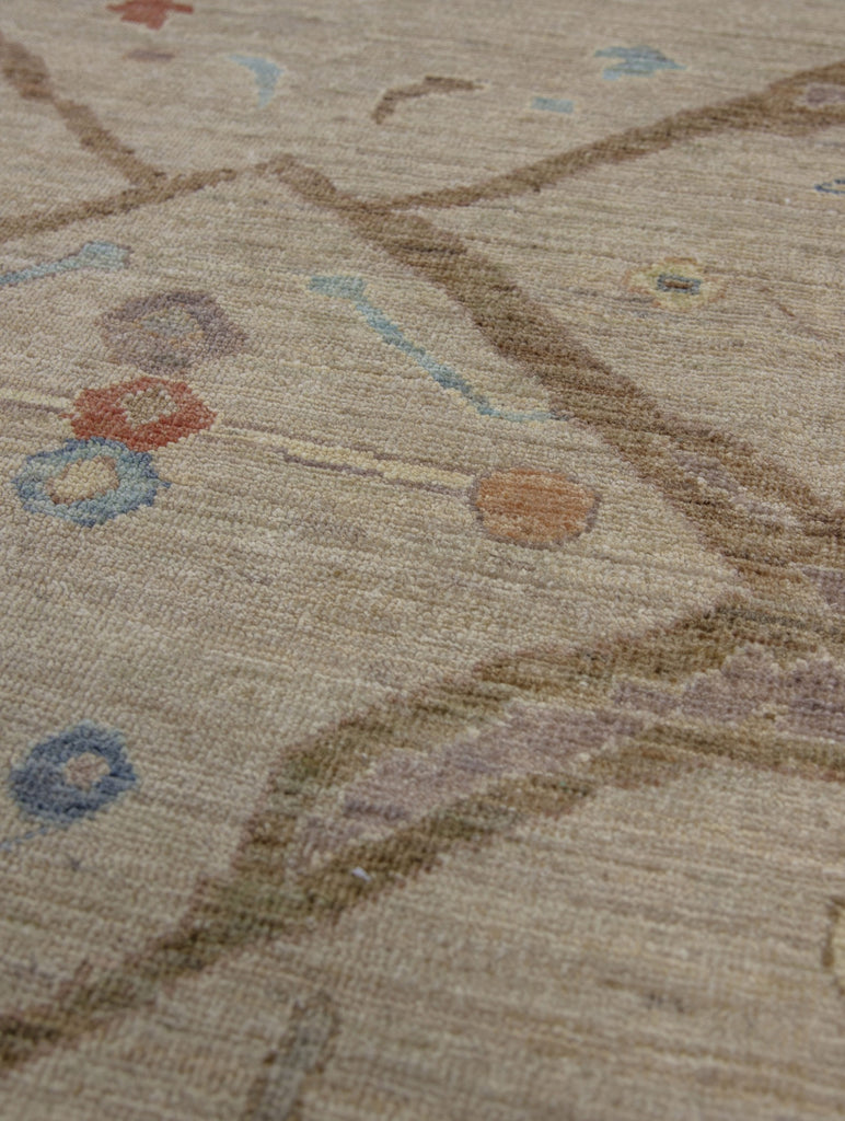 Antique looking tan, coral, lavender purple, yellow and blue traditional wool rug with round circles.