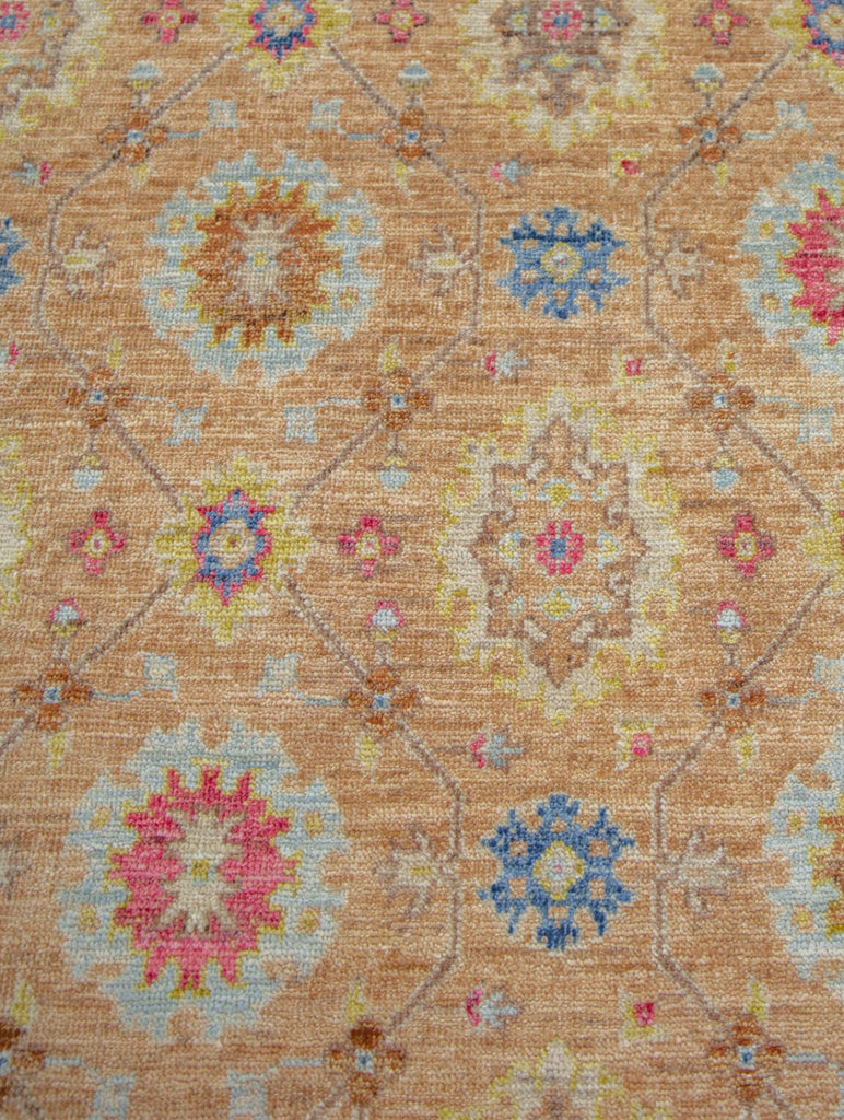 9x12 modern traditional Turkish oushak wool rug in pastel orange, green patina, coral, apricot, yellow and ivory colors.