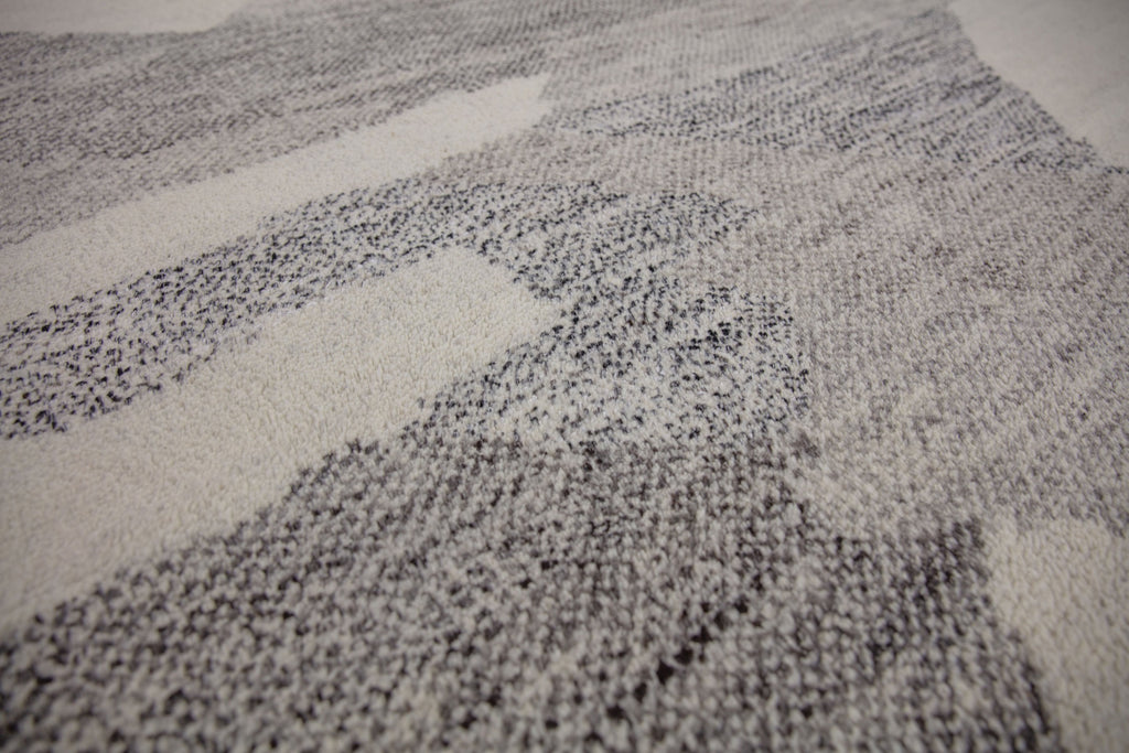 Hand Knotted wool and viscose rug with a soft pile and geometric design inspired by the African landscape. Bohemian look with ivory, gray, brown and black colors.  