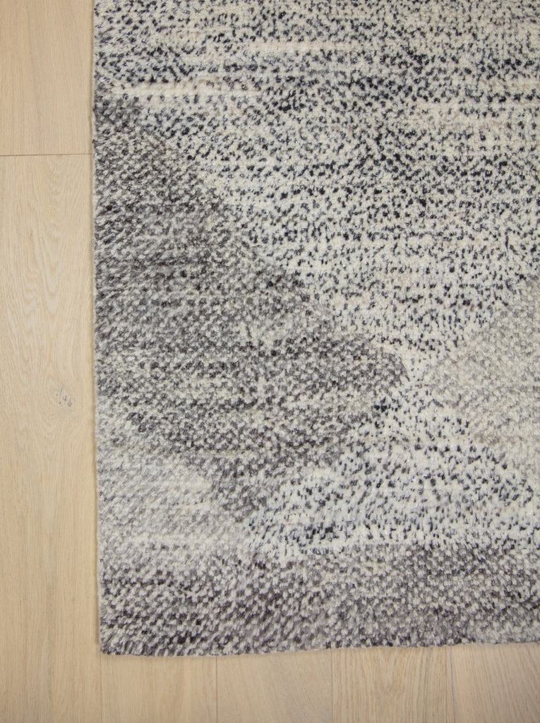 Hand Knotted wool and viscose rug with a soft pile and geometric design inspired by the African landscape. Bohemian look with ivory, gray, brown and black colors.  