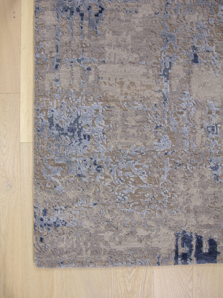 Modern 8x10 navy blue area rug made of wool and bamboo silk and accent light blue, beige, grey and taupe colors.