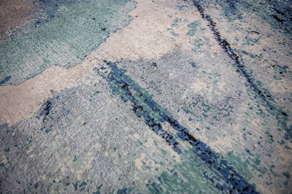 Inspired by the lagoons in the Southeast, the Biscayne collection lifts any contemporary room needing a pop of color. The show stopping, abstract patterns will bring life into any interior. Hand knotted in India of wool and silk, the Biscayne collection will stand the test of time with its exquisite craftsmanship. Handknotted teal, turquoise, grey, abstract, modern, contemporary rug.