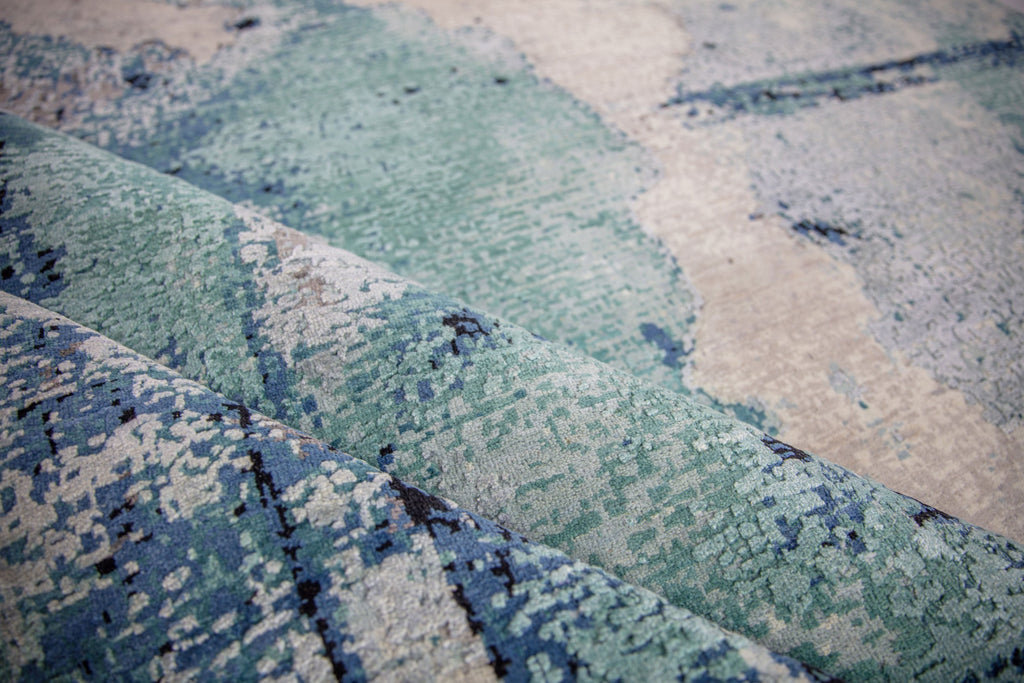 Inspired by the lagoons in the Southeast, the Biscayne collection lifts any contemporary room needing a pop of color. The show stopping, abstract patterns will bring life into any interior. Hand knotted in India of wool and silk, the Biscayne collection will stand the test of time with its exquisite craftsmanship. Handknotted teal, turquoise, grey, abstract, modern, contemporary rug.