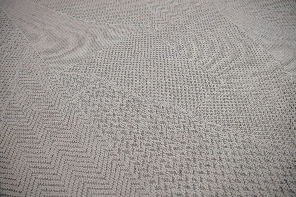 handcrafted Claire CL-02 Ivory color by Roya Rugs. 3D textured, hand-carved and wool rug. Neutral Ivory/White color with hints of gray. Geometric pattern, but solid rug from a distance. Contemporary Modern wool and cotton rug available in sizes of 18x18 samples, 2x3, 6x9, 8x10, 9x12, 10x14 and oversized 12x15