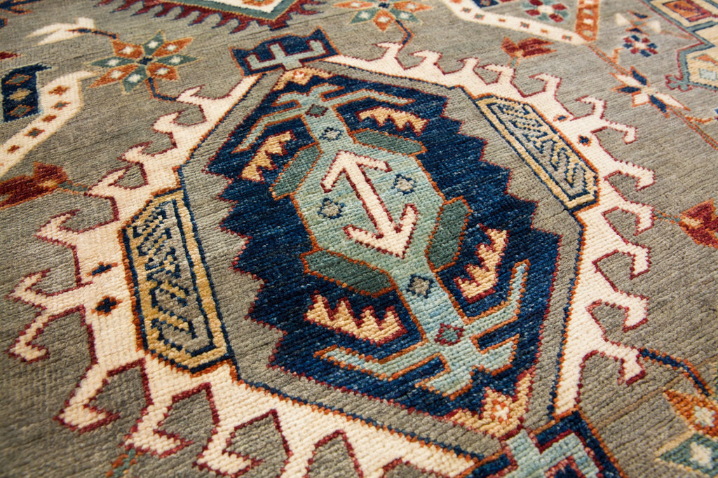 6x9 hand knotted quality oriental southwest tribal wool rug in elephant grey and ivory with deep wine red, teal accent, green, navy blue, gold and ivory colors with geometric design. Roya Rugs Asheville North Carolina.