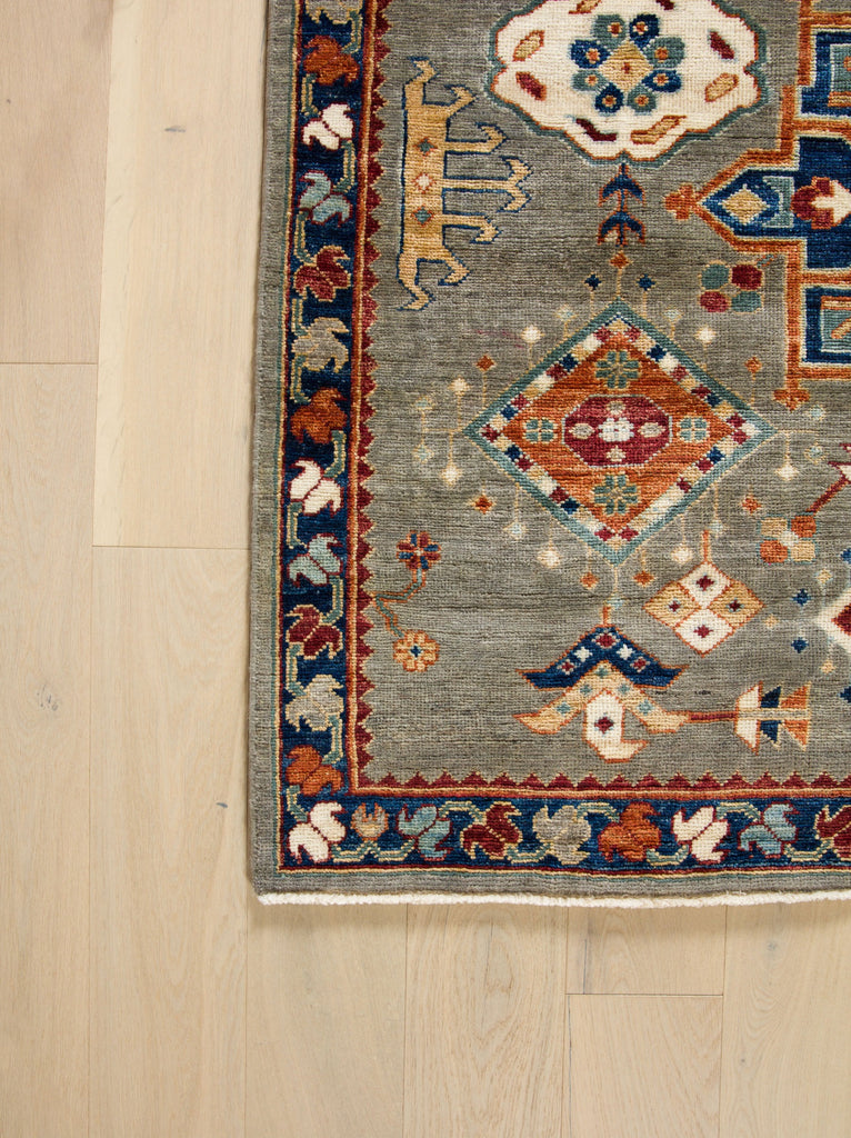 6x9 hand knotted quality oriental southwest tribal wool rug in elephant grey and ivory with deep wine red, teal accent, green, navy blue, gold and ivory colors with geometric design. Roya Rugs Asheville North Carolina.